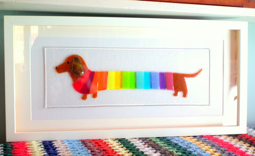 Solid glass, fused glass picture of dachshund wearing rainbow striped jumper. Framed glass wall art
